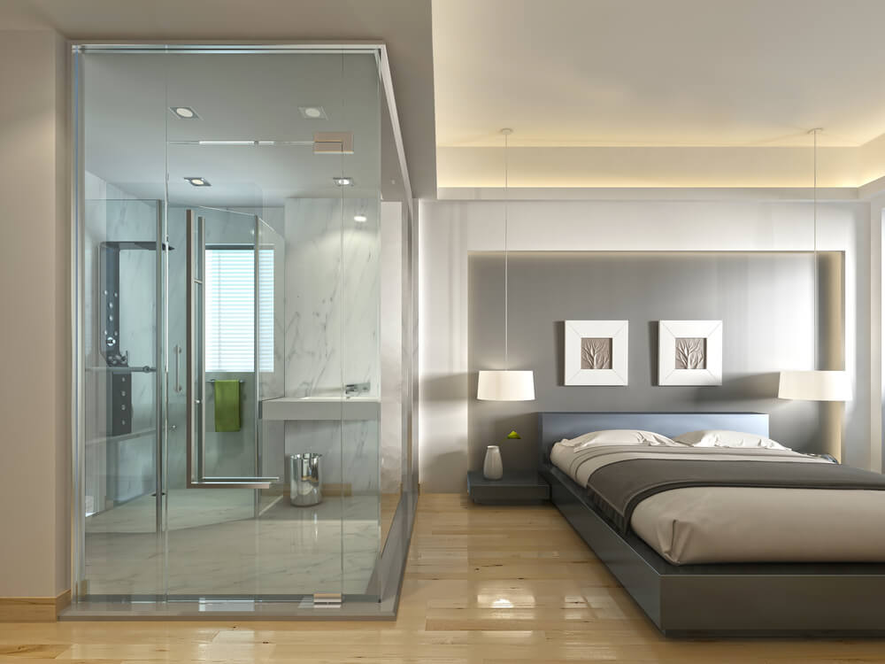 A stylish gray toned bedroom with an inset bathroom
