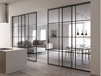 A classy glass wall including a sliding door to divide the kitchen and dining/living room