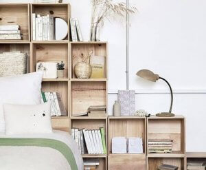A bedroom with wooden shelving.