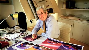 Giorgetto Giugiaro sitting at his desk.