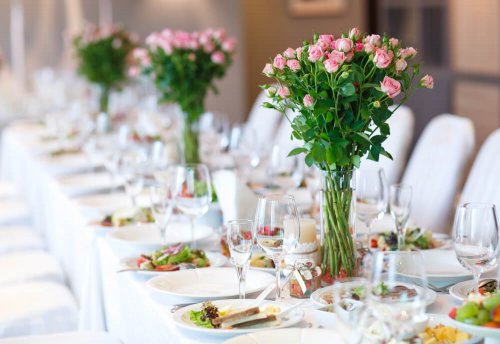 A table with floral arrangements.