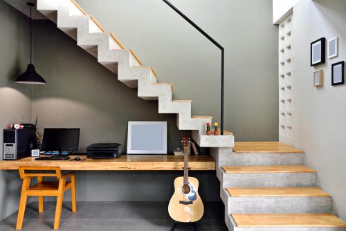 A desk in the space under the stairs.