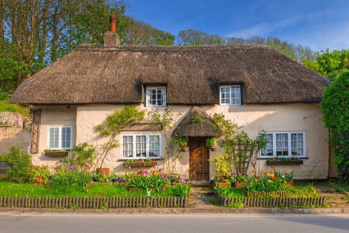 A cottage in the English countryside, relevant to the style of the zodiac sign of Sagittarius.