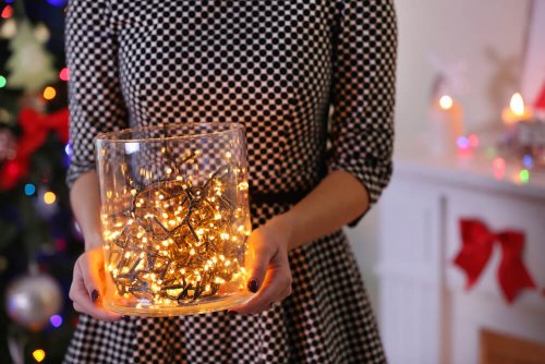 A woman holding an unusual lamp.
