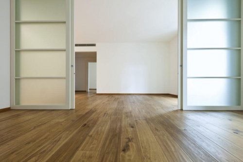 An empty apartment with sliding doors.