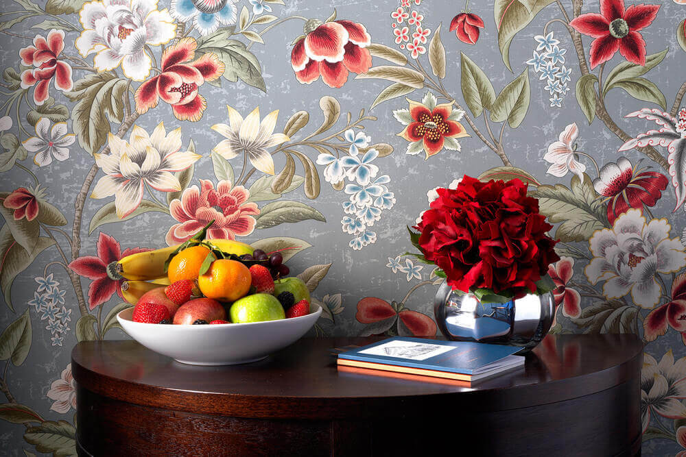 A bowl of fruit and a vase of flowers