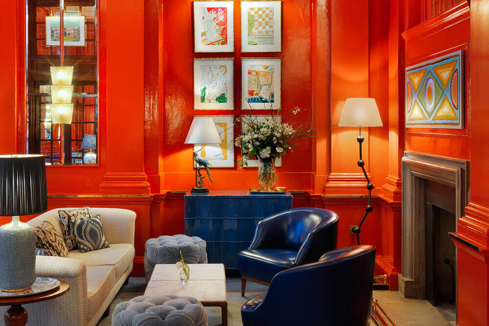 A living room featuring Bloomsbury style walls with paintings