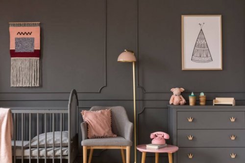 A gray kid's bedroom with a pale pink accent color
