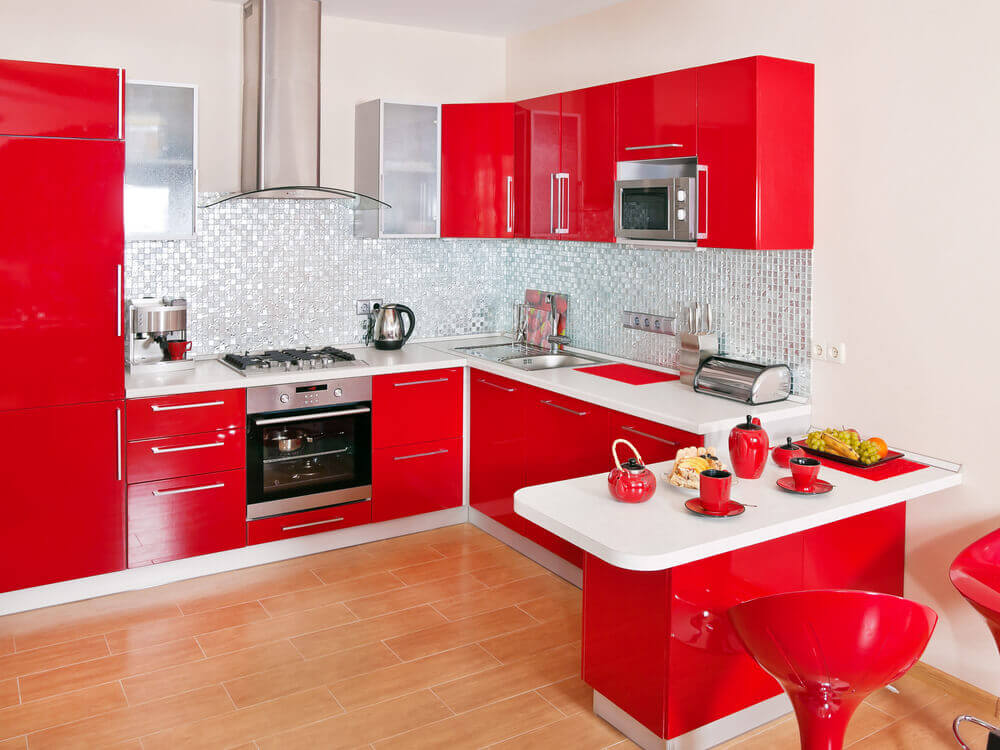 Red cupboards with white bench tops