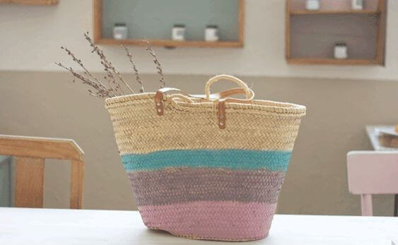 A beach bag with colorful painted stripes