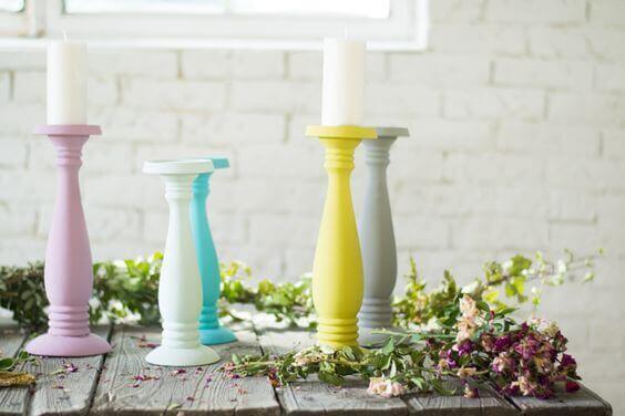 Colorful candle stick holders decorating a rustic table