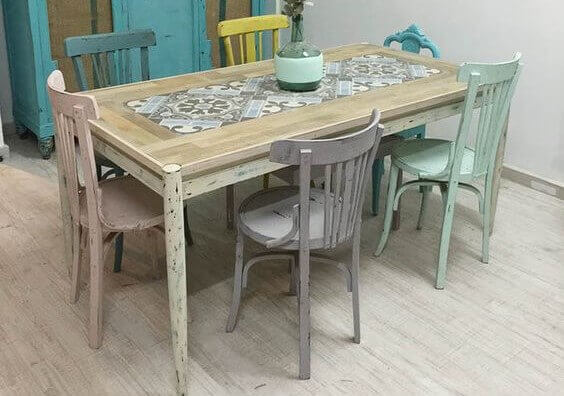 Dining chairs in pastel colors with a rustic timber table
