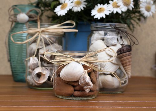 Glass jars with seashells and conches.