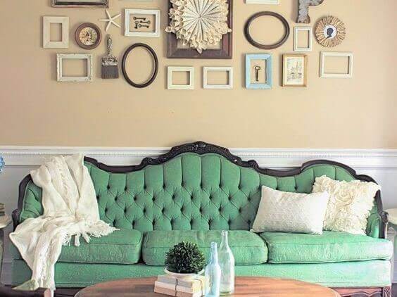 An antique sofa repainted using pale green chalk paint