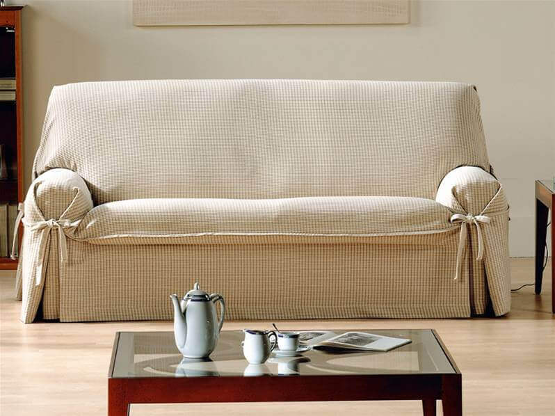 An adjustable beige sofa cover