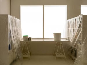 Drop cloths or plastic sheeting are essential for protecting both floors and furniture.