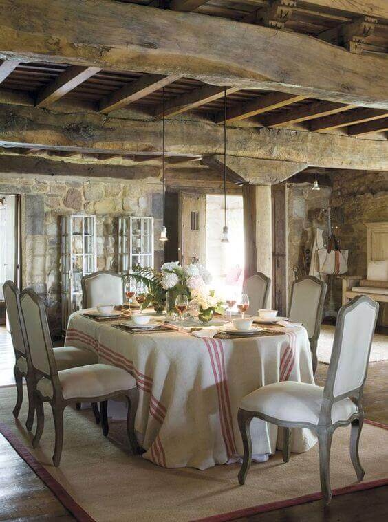 Thick oak beams, chairs with padded seats and backs and natural stone are keys to the French provincial style