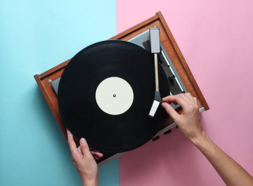 A person playing a record on a record player.