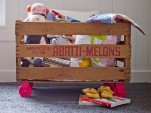 Using fruit crates as toy boxes.