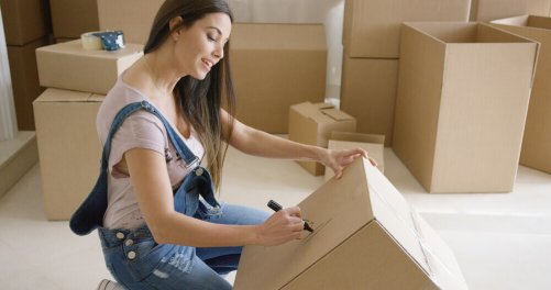 A woman numbering a box not doing this is something to avoid when moving.