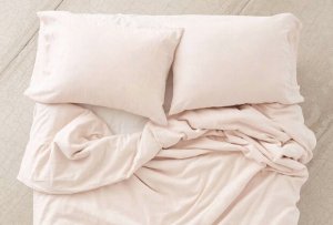 Pastel pink linen bed sheets.