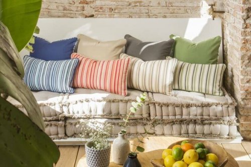 Various colorful cushions on a sofa.