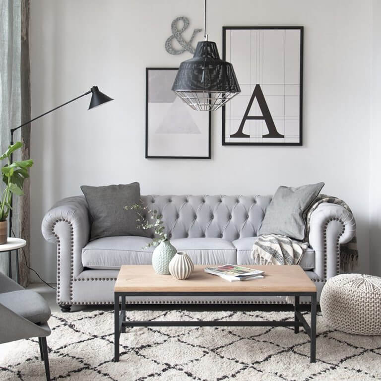 A timber coffee table and a gray Chester sofa