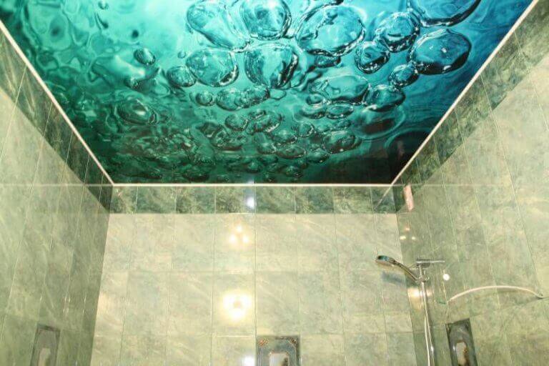 A back lit design of water bubbles above a shower