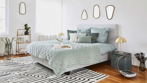 Large bed with aqua linens to update your bedroom
