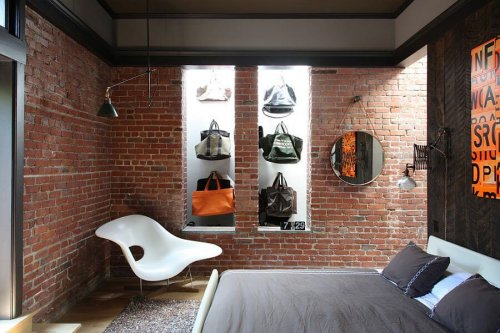A bedroom with a brick wall.