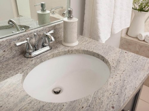 A bathroom with a granite countertop.