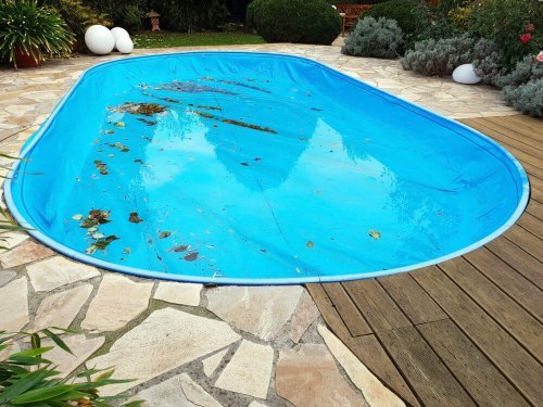 Pool with accumulated dirt on the bottom