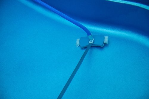 Picture of a pool vacuum on the bottom of a pool