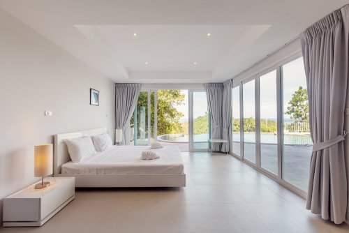 A white bedroom with white walls. Painting the walls of your bedroom white will give out better lighting to the whole space.