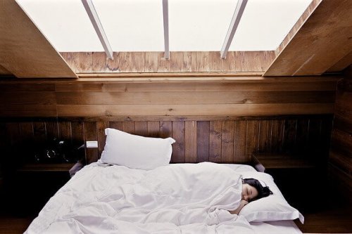 A woman asleep in an attic.