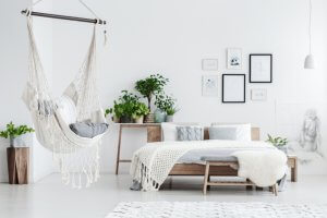 A white bedroom with a hammock.
