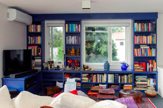 A home library with a dark blue wall.