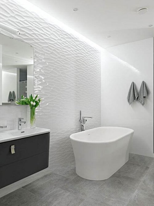 A bright bathroom with tiled walls.