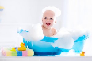 Child bathing in tub in bathroom