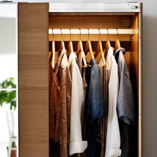 Coats hanging on wooden hangers.