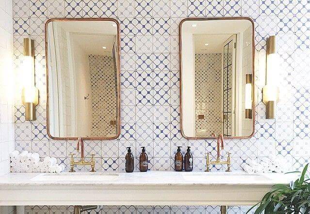 Two mirrors above sink.