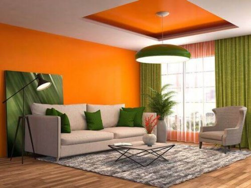 A living room with orange walls.