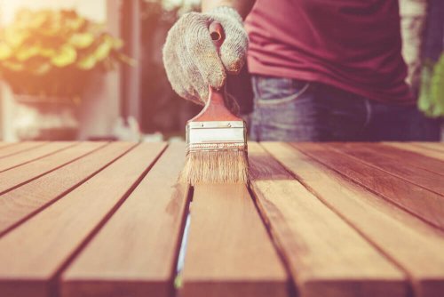 A man painting a table.