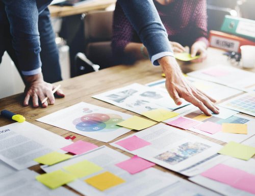 A person organizing documents on a table.