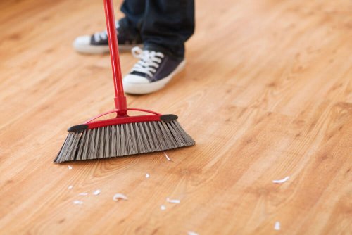 A person sweeping the floor.