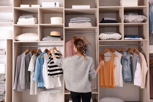 A woman organizing her clothes to get more closet space.