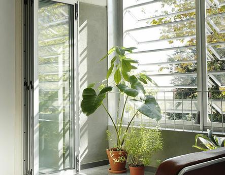 A bright room with one of the various type of windows.