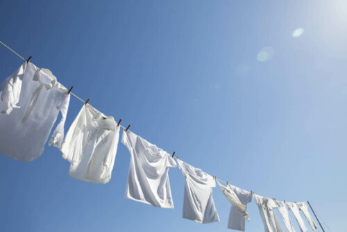 A clothesline full of white shirts.