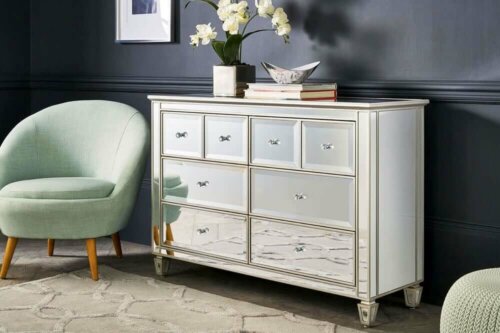 A commode with shinny drawers.