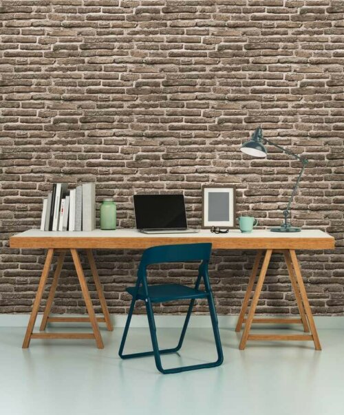 A desk in front a brick wall.